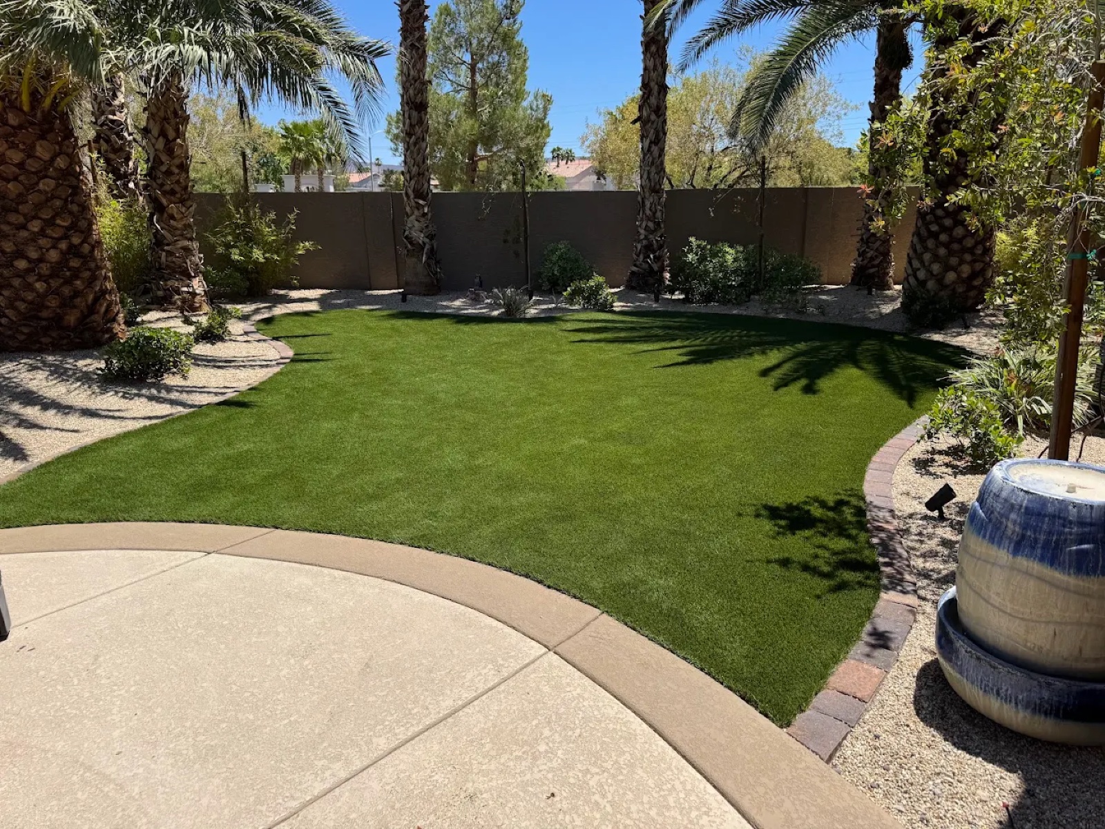 Luxury Las Vegas backyard with clean artificial turf and palm trees
